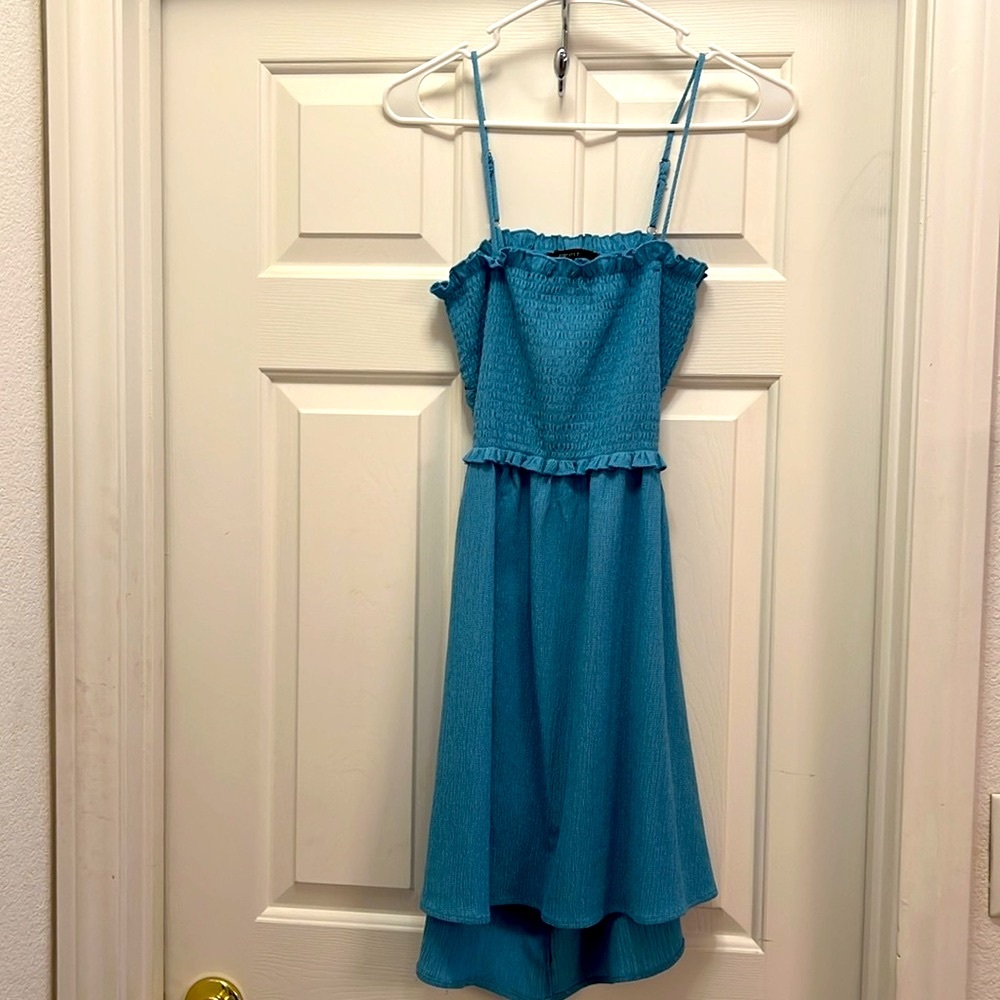 Adorable teal cut-a-way back spring/summer dress. Stretchable top.